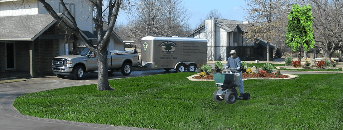 George Snouffer fertlizing green lawn with Landscape Outfitters' truck and trailer in the background